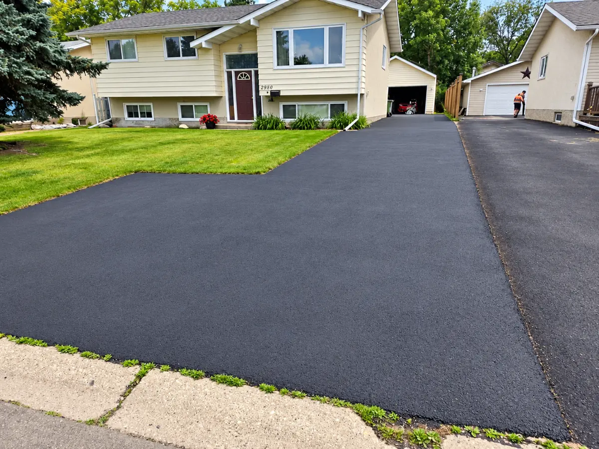 Smooth new asphalt driveway at a bi-level home